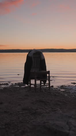 jacket on a chair by the water at sunset