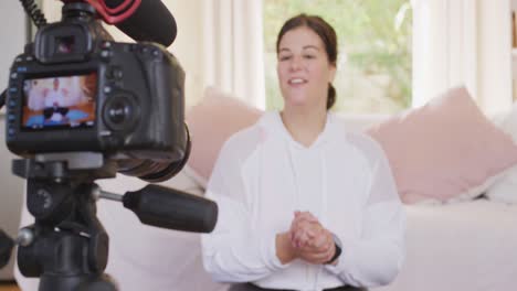 caucasian blogger woman doing a video at home