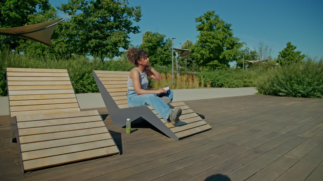 Woman reading a book in the park