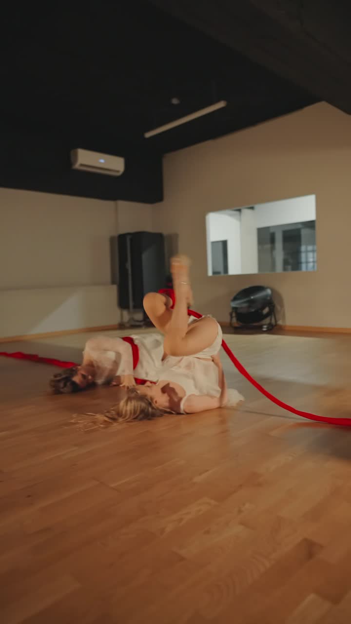 Acrobatic Dance Performance with Red Ribbons