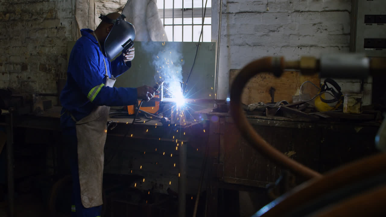 Metalsmith using welding torch in workshop 4k