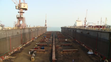 tilting down shot of dry dock being prepared to receive ship