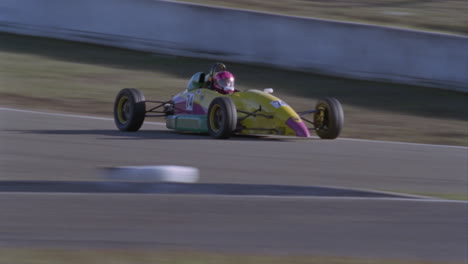 a formula car drives on a circuit track 13