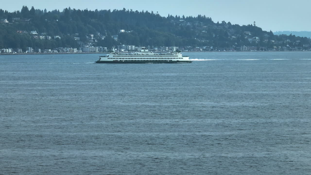 Telephoto drone shot following Washington state ferry on the Elliott Bay, Seattle