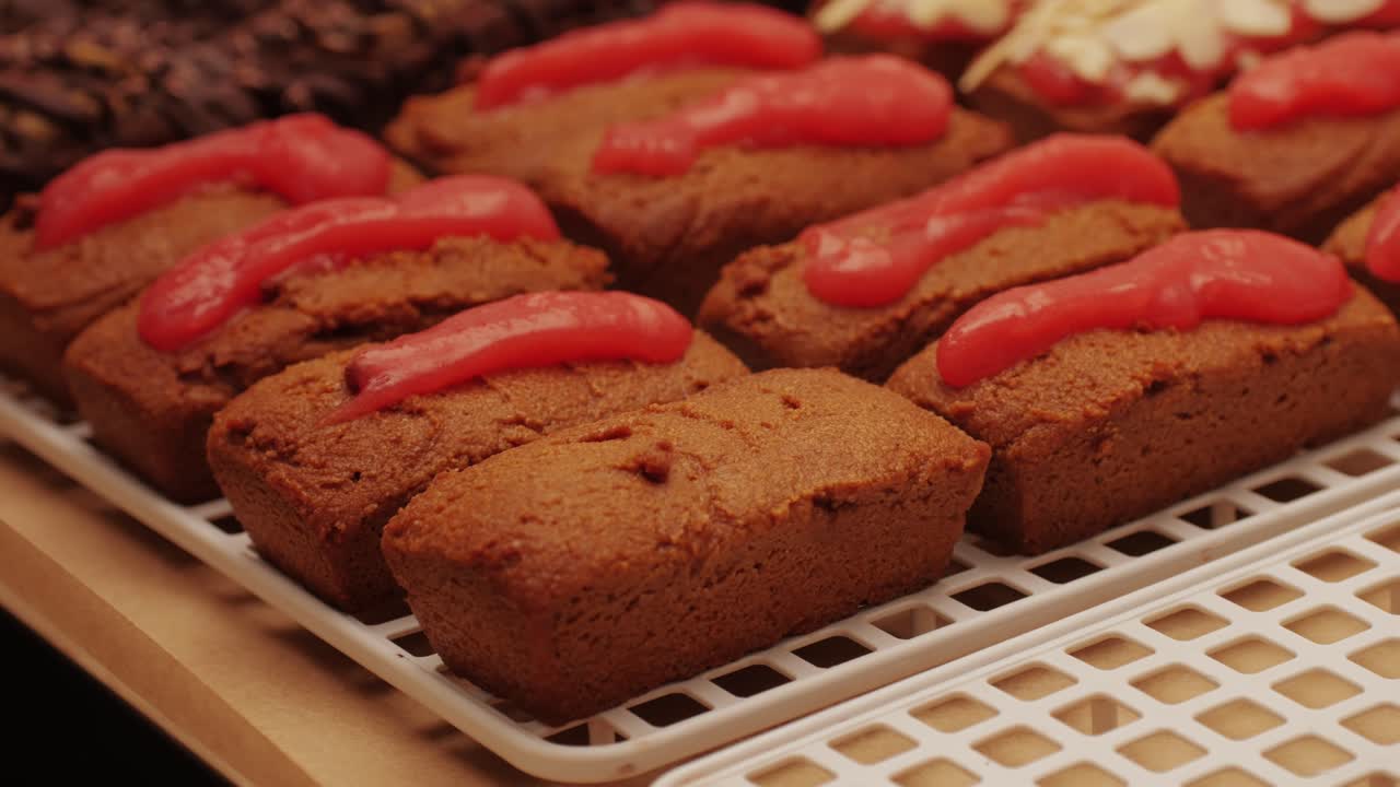 Artezan bread with red strawberry jam on top, fresh bake double chocolate banana artesian bread in bakery shop close-up. Artisan bread is making by skill bakers using natural and high-quality ingredients. Food with health and flavour benefits. Sweet breads for dessert and breakfast