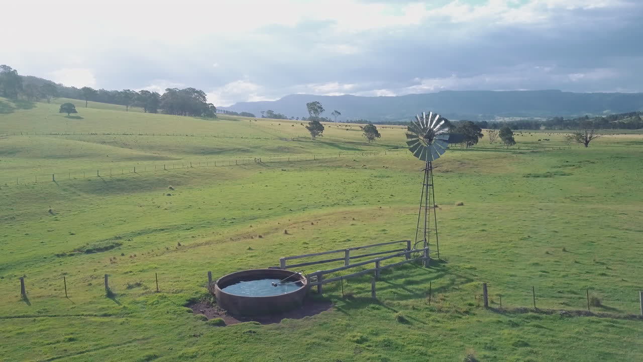 Old Fashioned Windmill In A Countryside Landscape Near Berry, New South Wales At Daytime - aerial drone shot