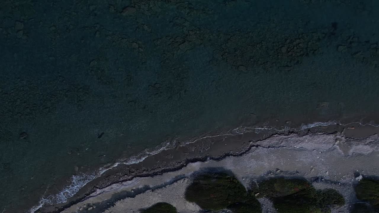 Aerial view of rocky coastline in Greece with clear blue water