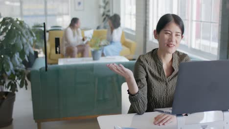 happy casual businesswoman having laptop video call in office in slow motion