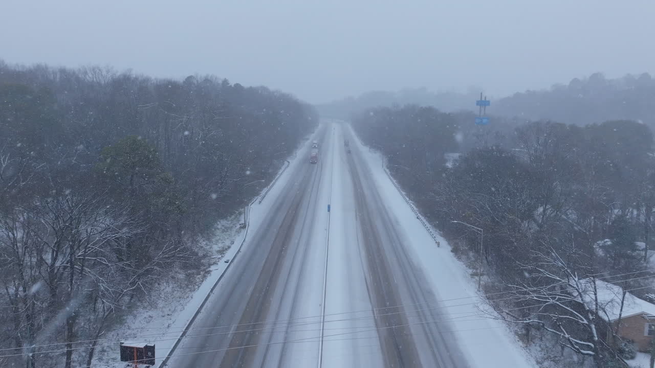 Aerial footage flying above a highway during a snowstorm in Chattanooga, TN.