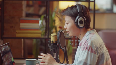 asian woman podcasting at home