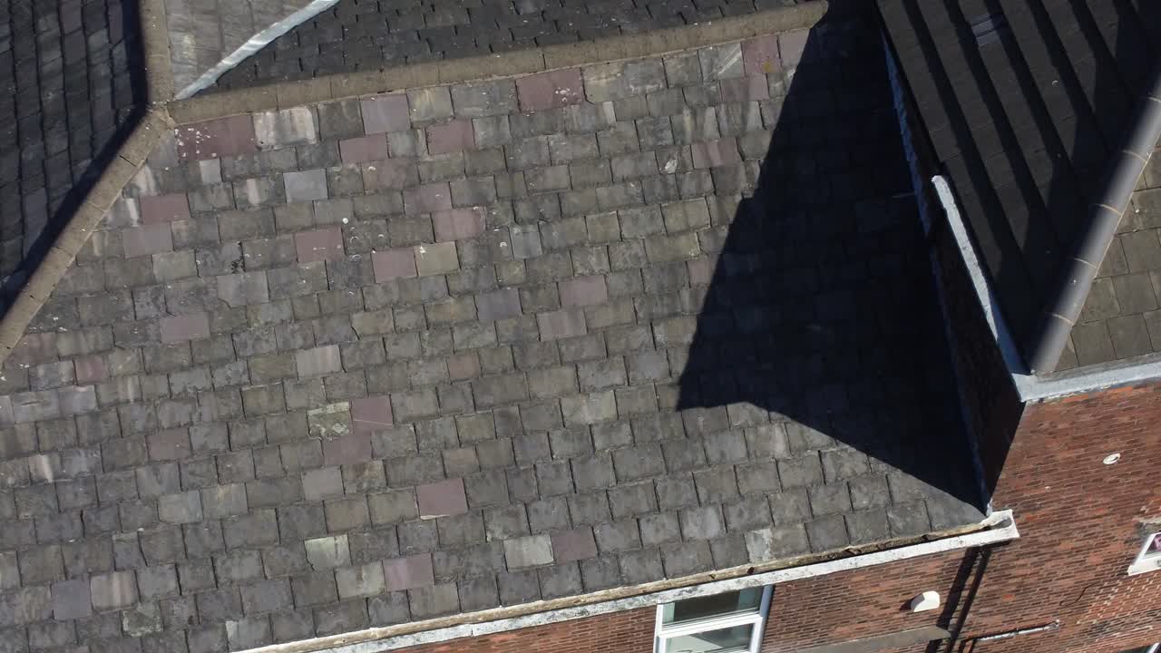 Rooftop survey aerial view inspecting damage and repair of real estate for homeowner