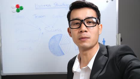 asian businessman making conference video call with smartphone