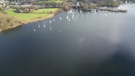 Sailboats-anchored-in-marina-near-shoreline,-Aquatic-Quays-Marina,-Windermere