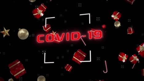 animation of covid 19 text with candy canes and christmas decorations falling on black background