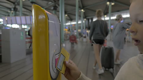 child using ticket scanning machine