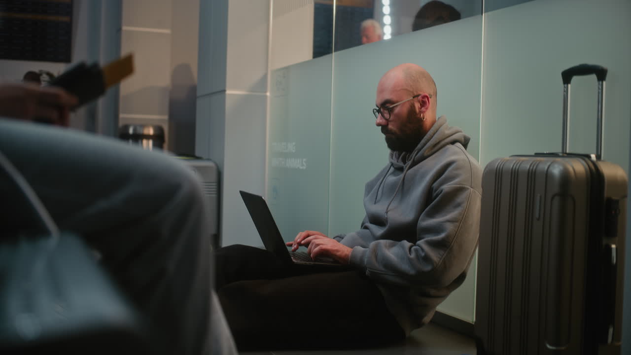 Man working on laptop at the airport