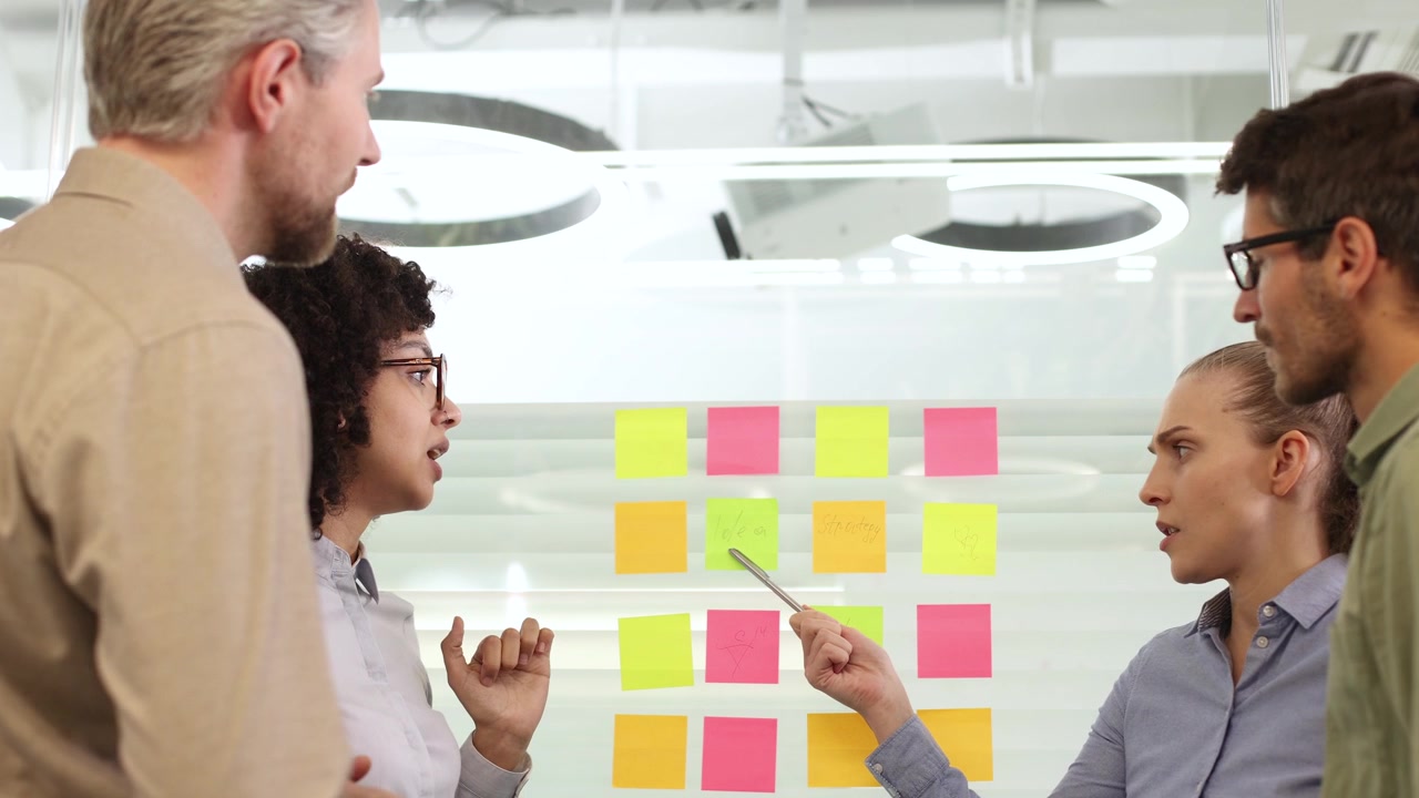 Diverse Business Team Brainstorming Ideas on Glass Board