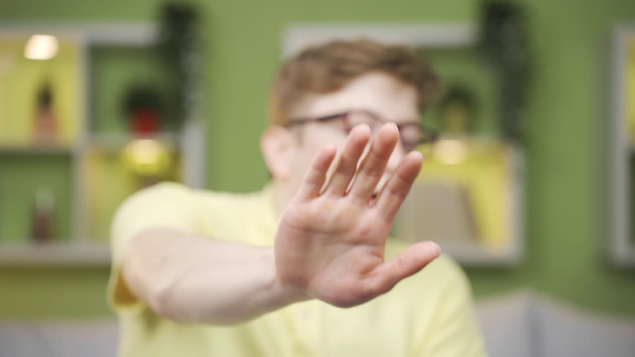 Close-up of young man looking at camera scared.