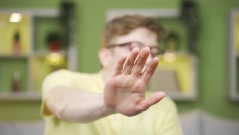 close-up of young man looking at camera scared.