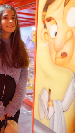 woman next to a mr. bean cartoon at an amusement park