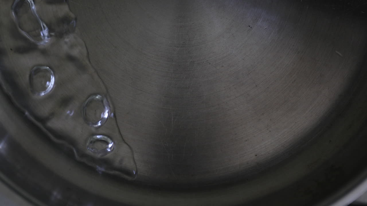 boiling water gently moving back and forth in a steel pan | freepik