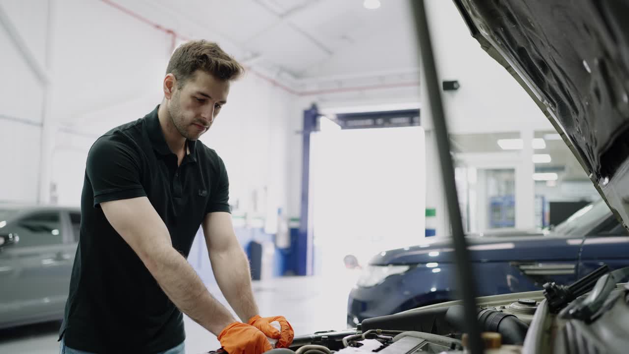 Mechanic checking car oil