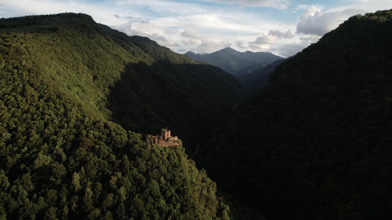 Cinematic drone pan with orbit around Colț Fortress in Romania, surrounded by lush green Carpathian Mountains. Epic medieval ruin in scenic natural landscape, 4K.