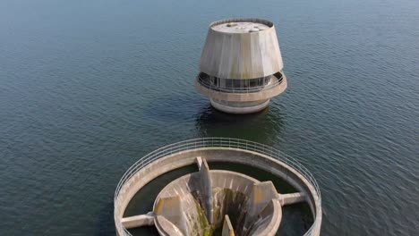 aerial flyover draw off tower at bewl water reservoir during summertime, kent bewl water