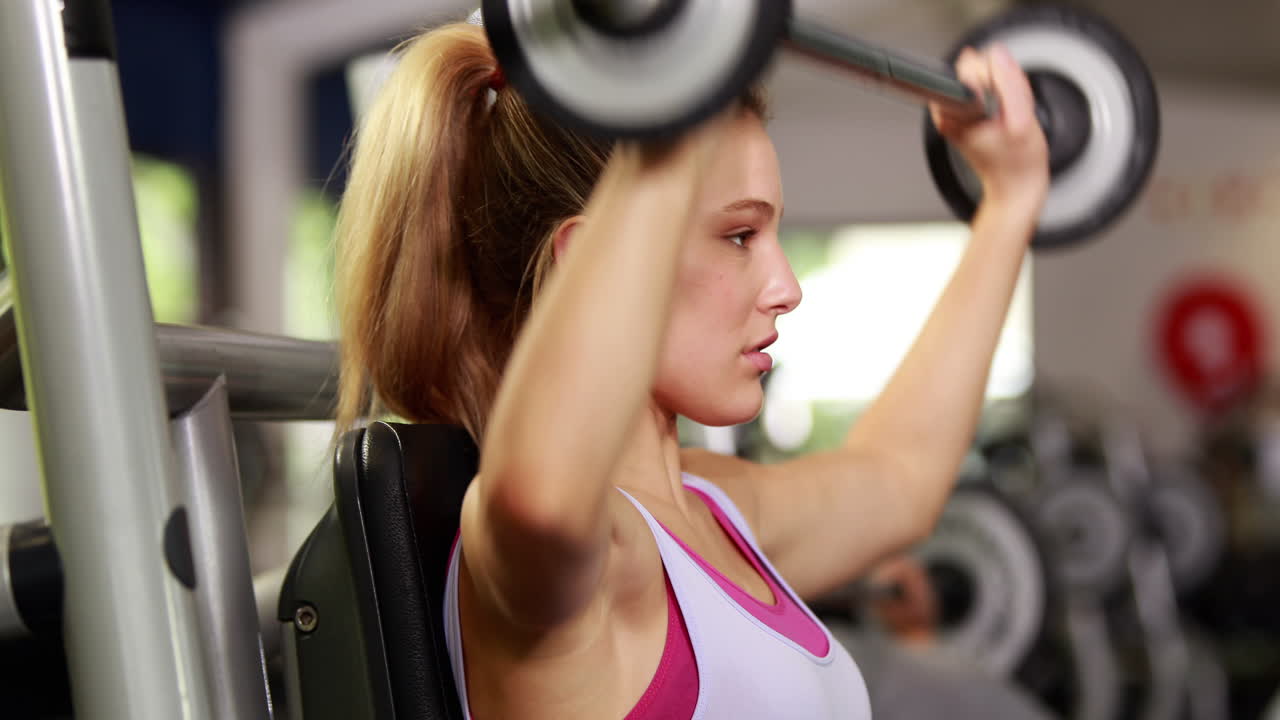 Fit woman lifting dumbbell