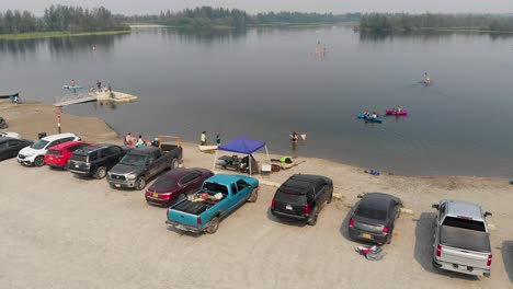 4k drone video of swimmers and paddle boarders on cushman lake in fairbanks, ak during summer day
