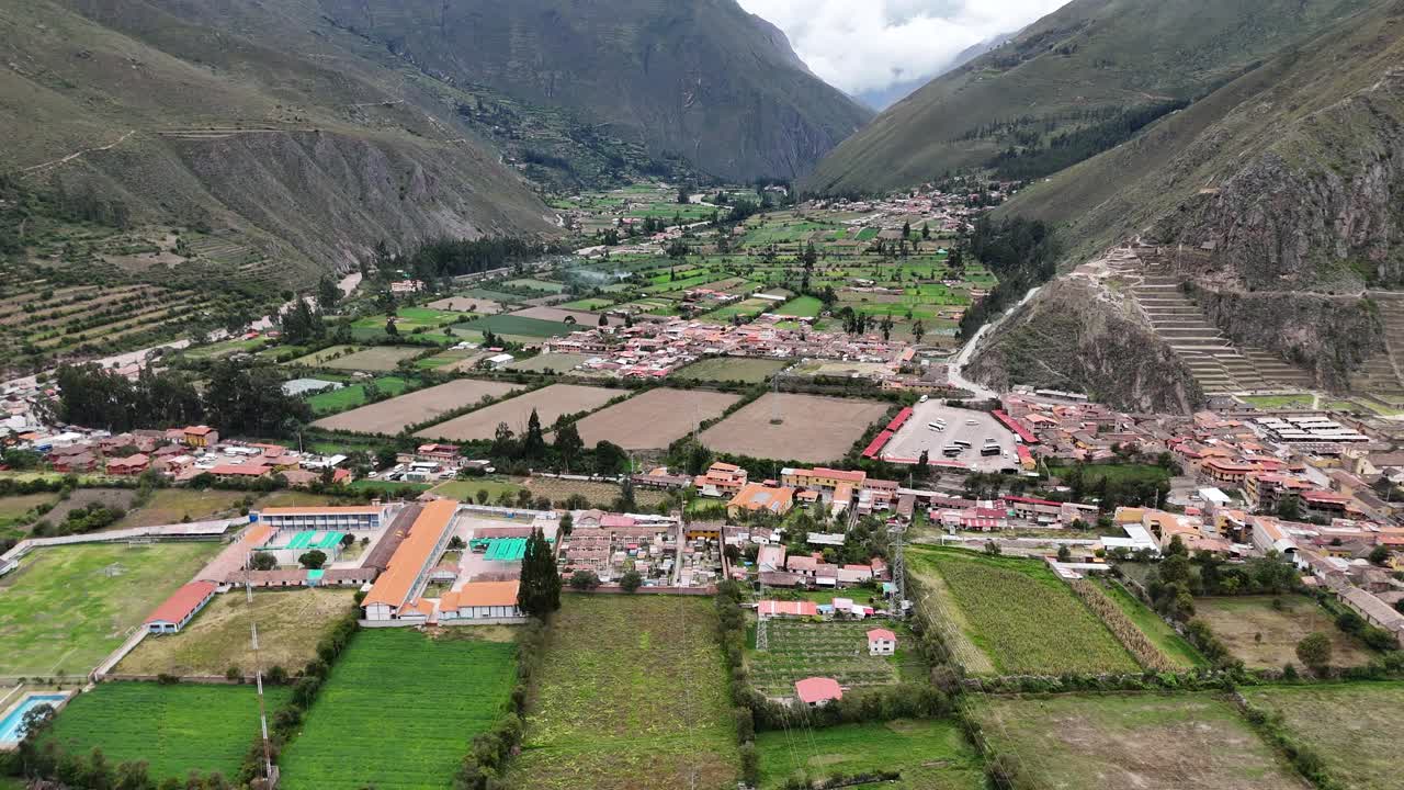 Aerial Drone view of Ollantaytambo Inca city town in Peru mountains and Inca ruins Sacred Valley