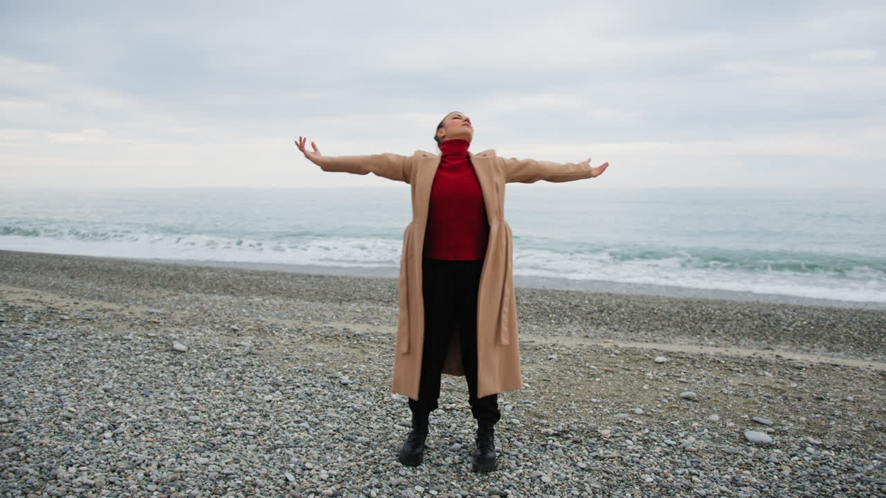 Woman Dances Near The Dull Ocean In A Peaceful And Relaxing Atmosphere