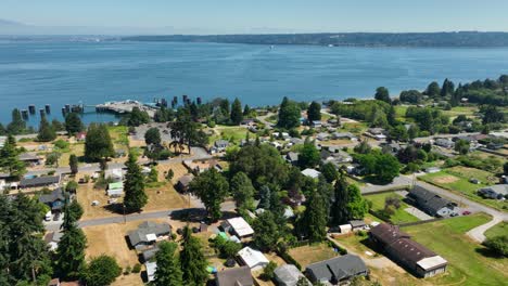 Drone-shot-over-the-Clinton,-Washington-community-with-the-ferry-terminal-sitting-vacant-awaiting-its-next-ferry