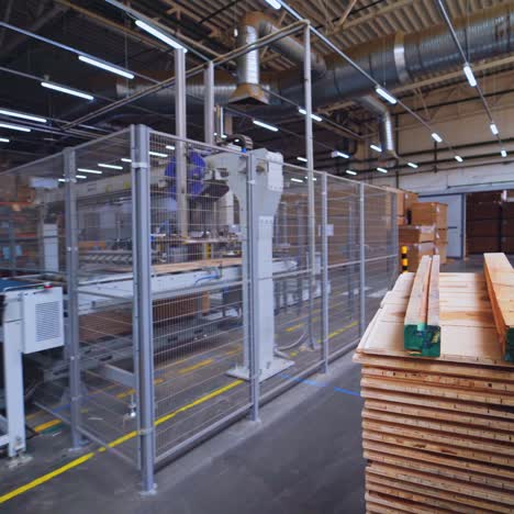 warehouse of wood. piles of boards inside the huge factory for parquet production. electronic cart for carrying wooden material.