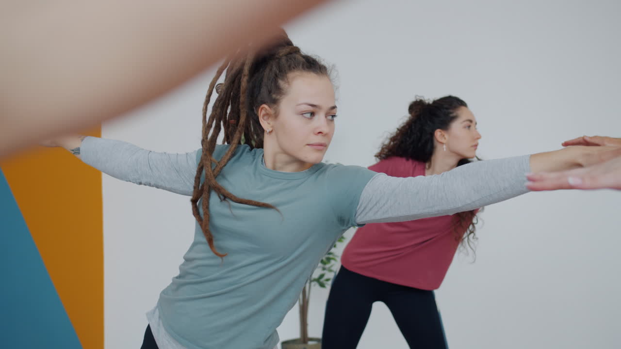 Women practicing yoga poses in a class