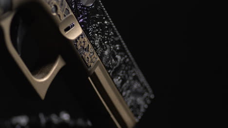 closeup of laser engraved single-action pistol. custom firearms. studio shot