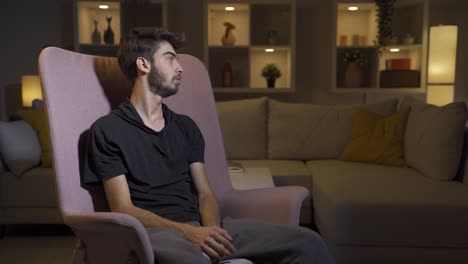 un hombre deprimido cubriéndose la cara con la mano.