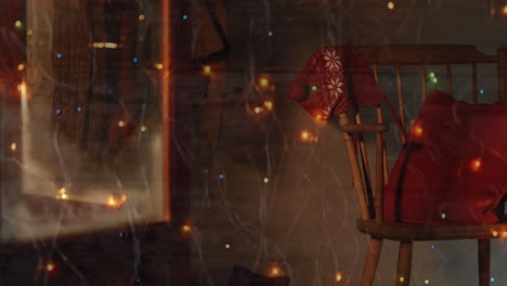 digital composition of colorful fairy lights against christmas beanie on wooden chair at home