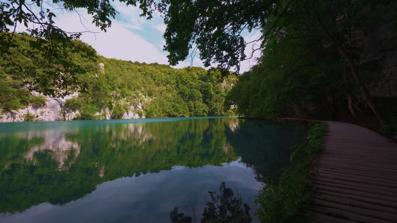 Plitvice Lakes Croatia with turquoise water framed by lush green spring forest and wooden paths