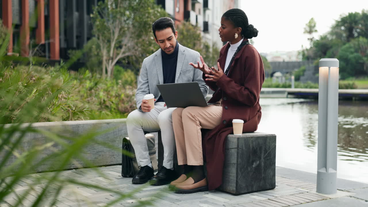 Two Business People Have a Casual Meeting by a Waterfront in a Modern City