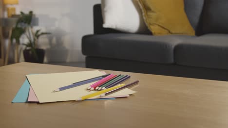 coloured pencils and paper on table at home for child diagnosed with asd 1