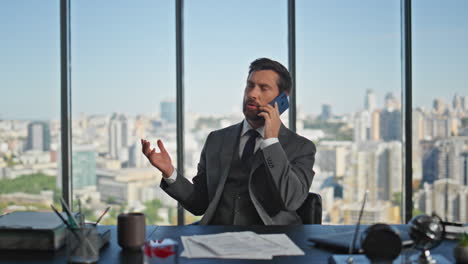 relaxed boss speaking telephone in office chair closeup. handsome man consulting