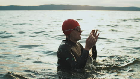 female triathlete resting after swimming in lake