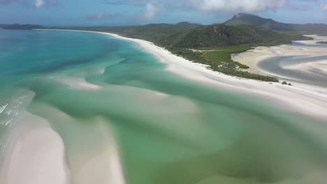 Rising-sunny-aerial-reveals-long-spotless-Whitehaven-Beach,-QLD-AUS