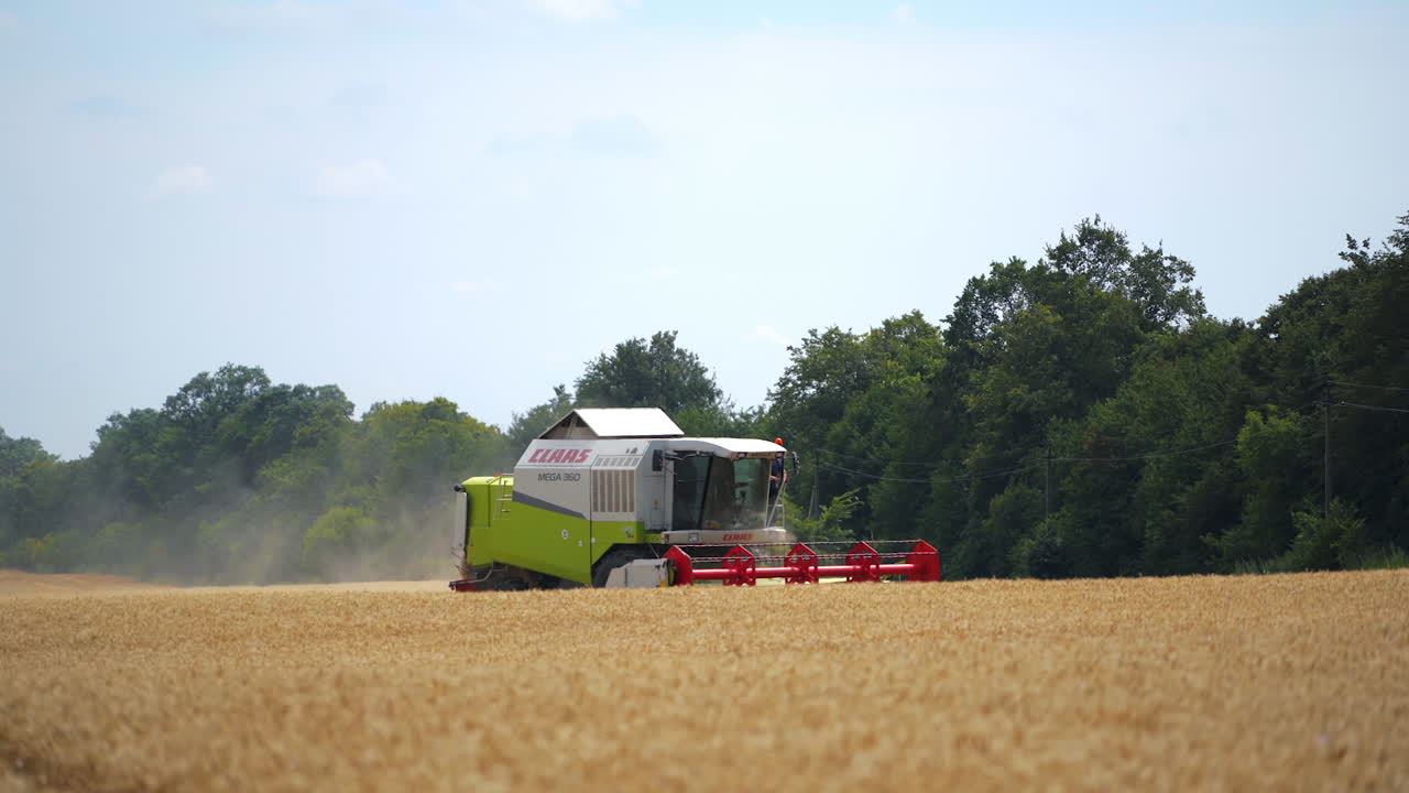 Farmer combining field of wheat. Agroindustrial industrial landscape with combine harvesters