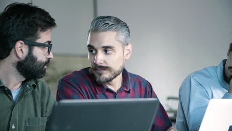 front view of concentrated developers working with laptops