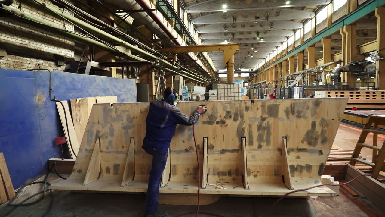 Worker Sanding Wooden Mold in a Factory