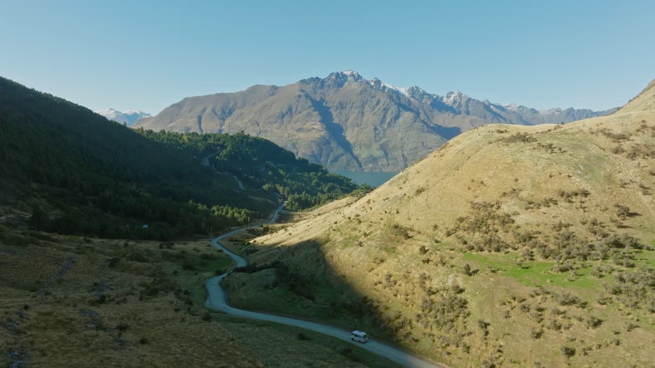 Aerial glimpse of majestic Moke Lake within mountainous landscape and campervan on road trip in Otago, South Island of New Zealand Aotearoa