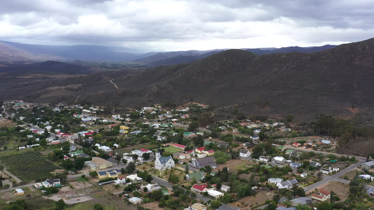 Beautiful South African city with wooden church and green vegetation along mount