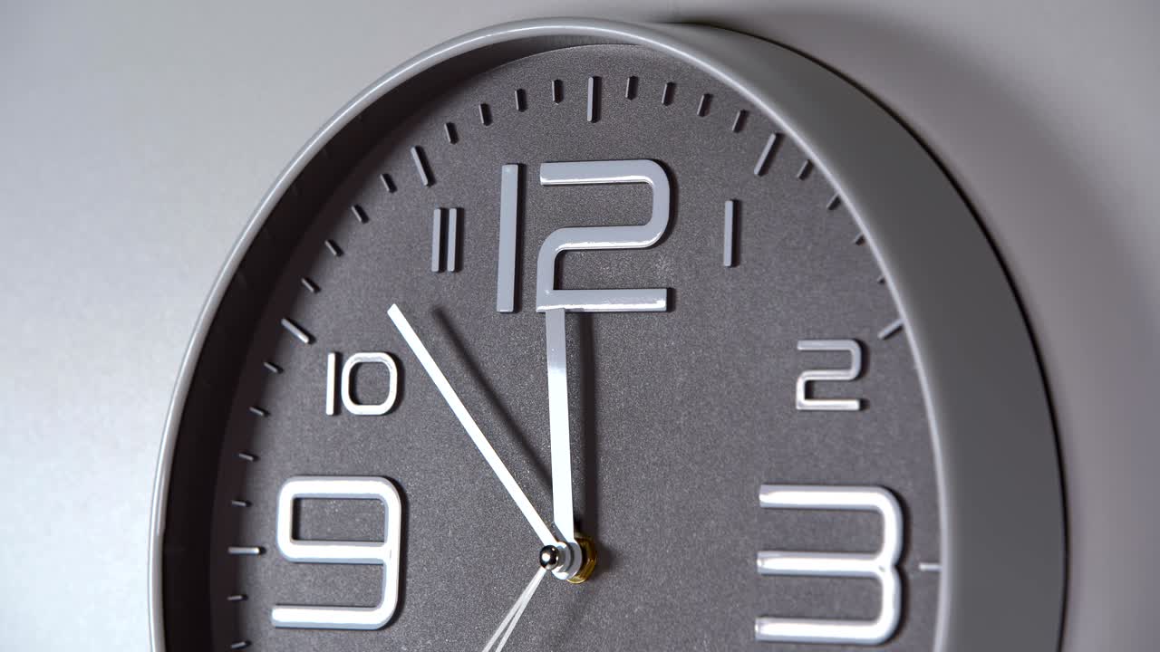 reloj de pared en un fondo gris. lapso de tiempo